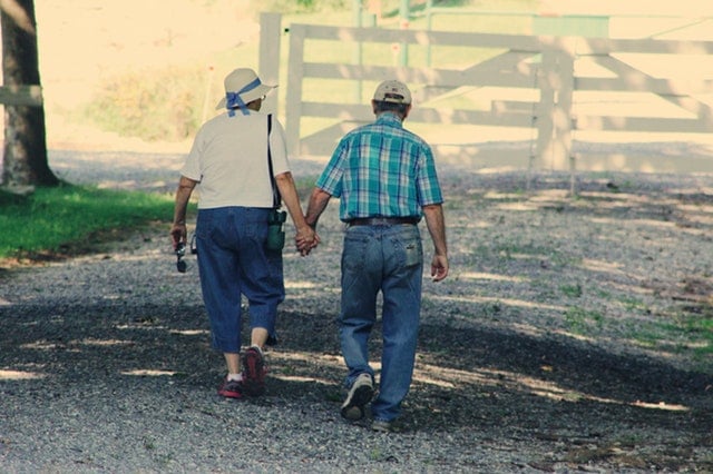 old-couple-walking-hand-in-hand-