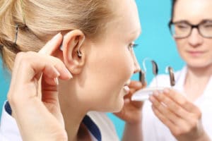 person-trying-on-a-hearing-aid-copy-300x200