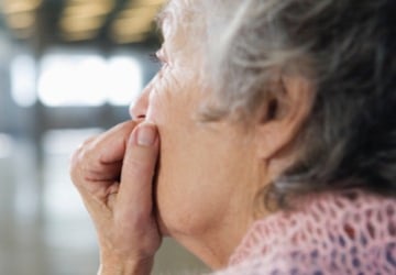 Photo of an older person looking thoughtful