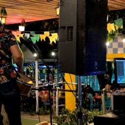 Musician playing guitar on a stage.