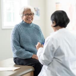 Older woman talking with her doctor.