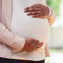 A close-up image of a pregnant woman's stomach
