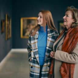 Two women looking at art in a museum