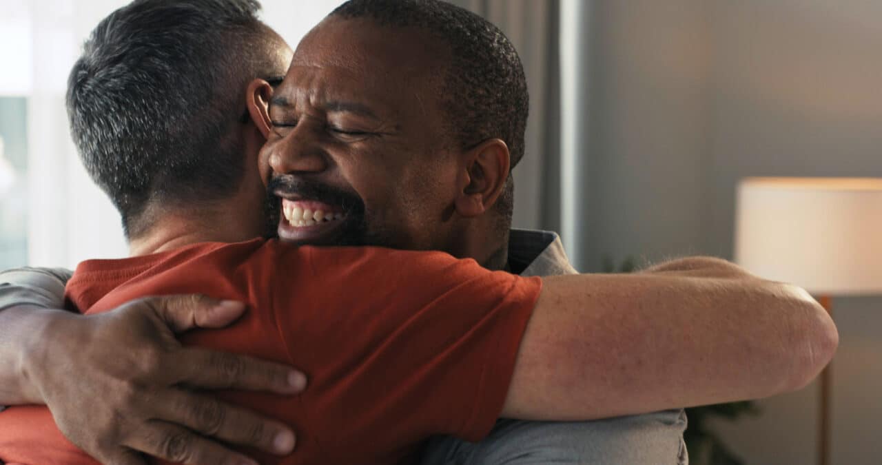 Offering support to a loved one, two people hugging.